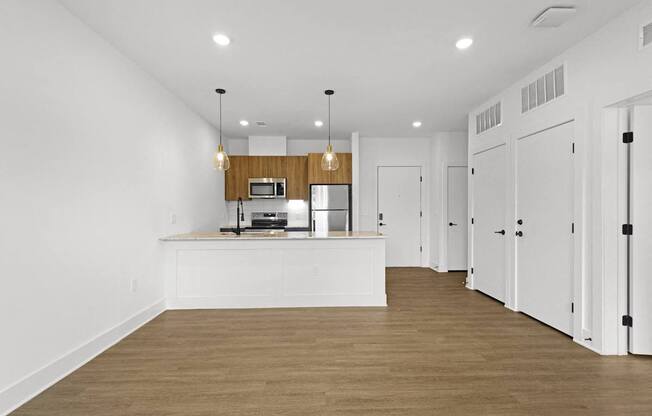 A kitchen with white cabinets and a wooden island.at Boardwalk at Research Park, Huntsville Alabama