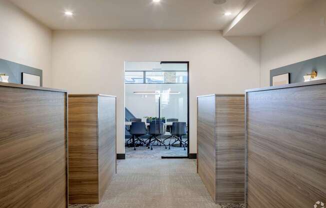 A conference room with a table and chairs in the background.