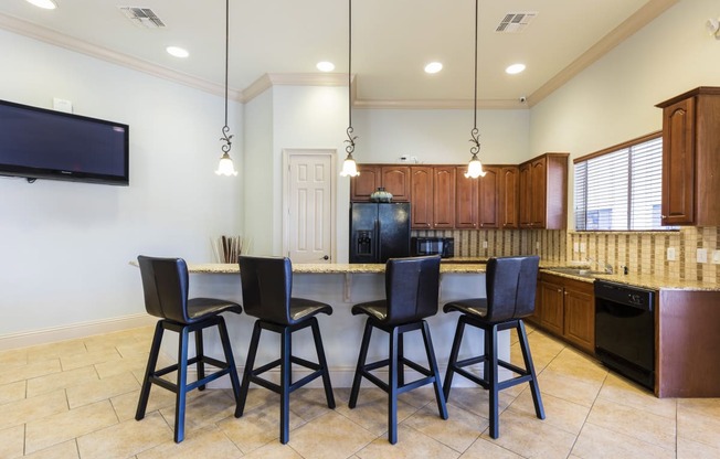 Rapallo Apartments community clubhouse kitchen area equipped with refrigerator, microwave, and dishwasher.