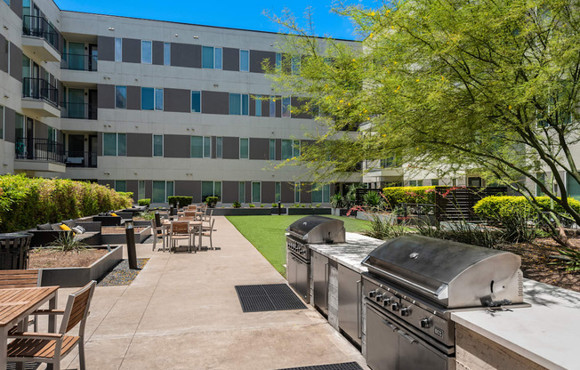 Outdoor Green Space with Grills and Lounge Seating