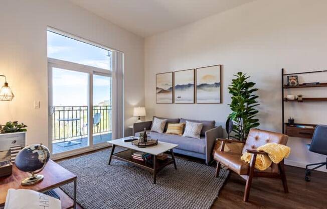 a living room with a couch and a sliding glass door