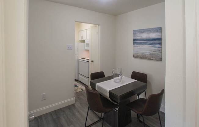 This is a photo of the dining room in the 558 square foot 1 bedroom, 1 bath model apartment at The Summit at Midtown Apartments in Dallas, TX.