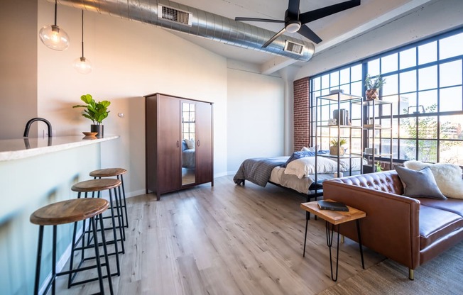 a bedroom with a bed and a bar in a room at The 22 Apartments, Missouri