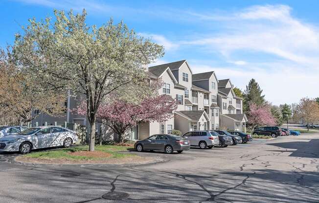 A parking lot with cars and apartments at the Ledges in Weymouth.