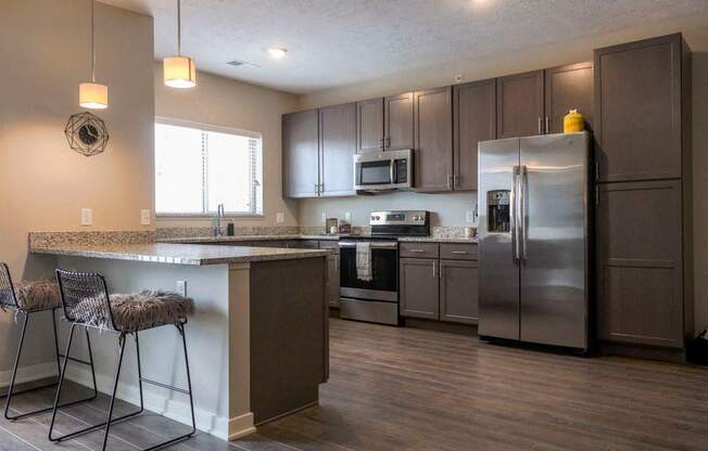 Large kitchen with stainless-steel appliances and peninsula at WH Flats new luxury apartments in south Lincoln NE 68516