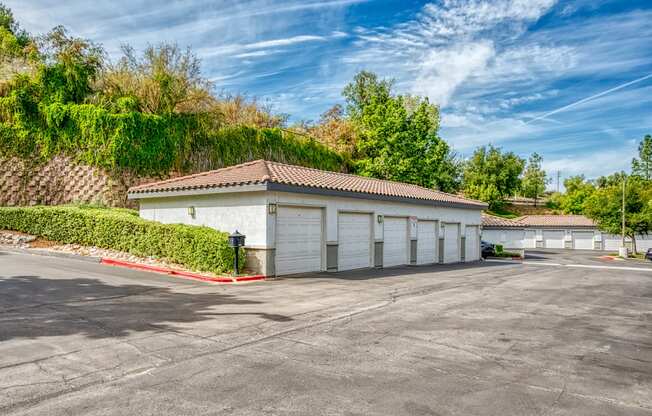 a garage with white doors and a parking lot at Canyon Crest, Riverside, CA