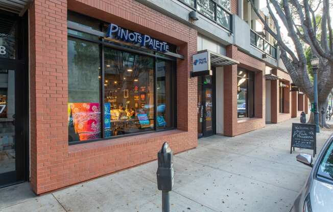 a brick building with a window and a parking meter