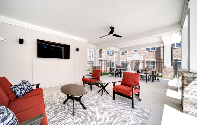 a living room with a couch and chairs and a television