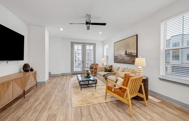 a living room with a couch and a tv at Meridian at CityPlace, Woodbury, MN