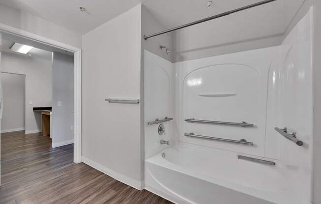 a bathroom with a tub and a shower in a house