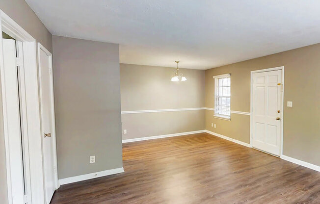 A room with wooden floors and white doors.