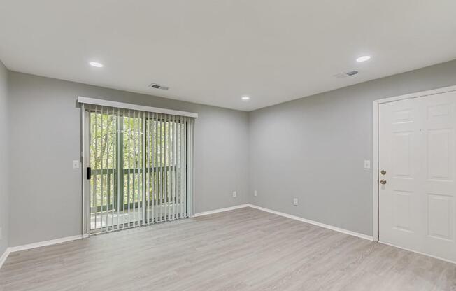 A room with a sliding door and a white door.