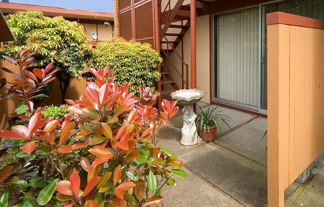 a porch with a fire hydrant in front of a building