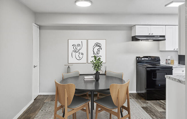Model Dining Room with Wood-Style Flooring and View of Kitchen at Tanque Verde Apartments located in Tucson, AZ.