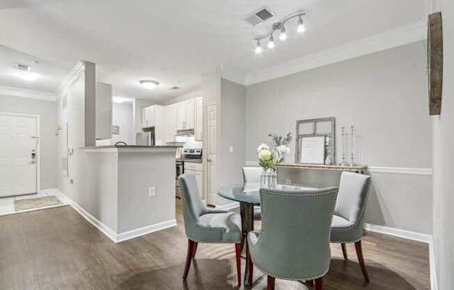 A kitchen with a table and chairs in the foreground.