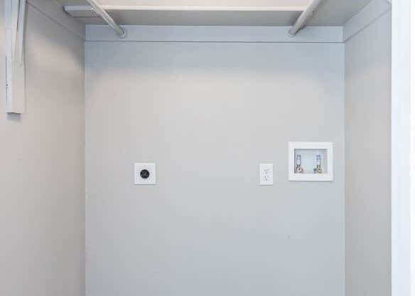 A small room with a white door and a white wall.