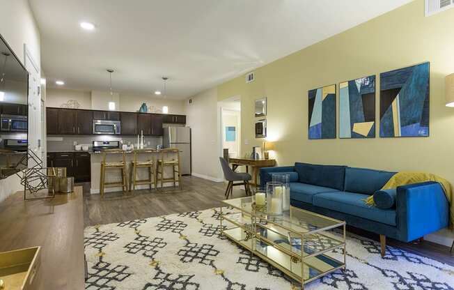 Living room with tv and couch and model kitchen at The View at Horizon Ridge, Henderson