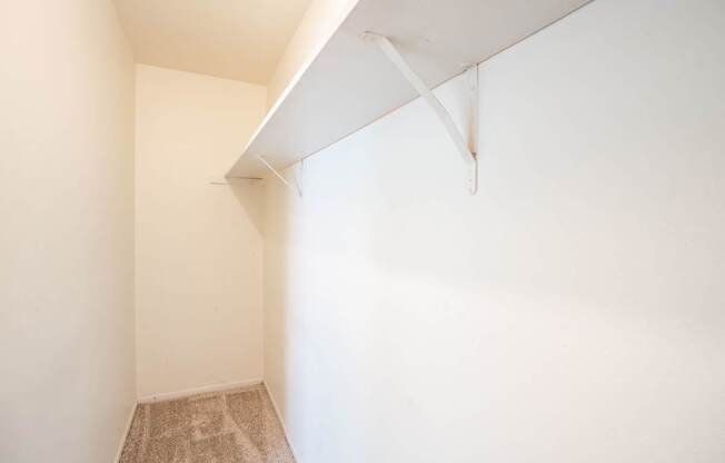 A room with a carpeted floor and a white ceiling. West Fargo, ND Sheyenne Terrace Townhomes