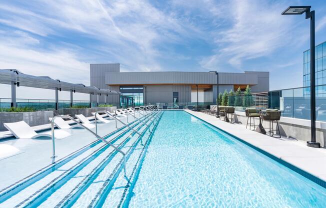 McGavock's rooftop pool with crisp sightlines, in-water loungers, and open-air seating creates a refined setting for daytime relaxation and skyline views.