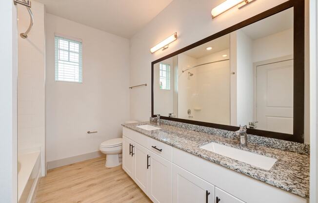 a bathroom with a sink and a mirror and a toilet at Legacy at Cibolo, Boerne, TX, 78006