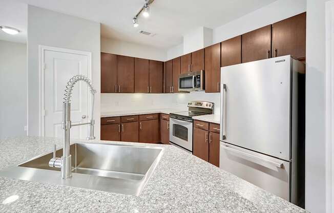 a kitchen with stainless steel appliances and granite counter tops
