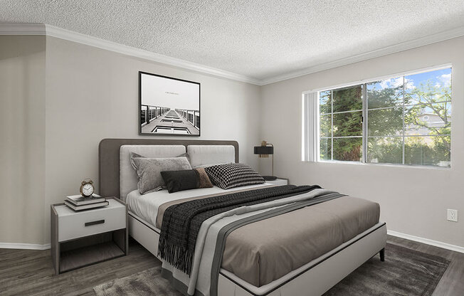 Carpeted bedroom with large window for natural light.