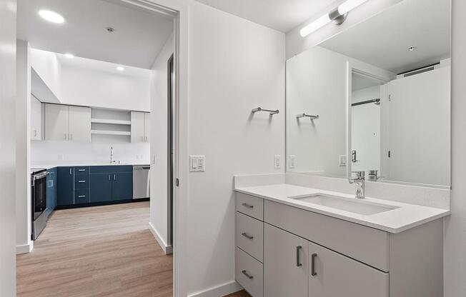 a white bathroom with a sink and a mirror