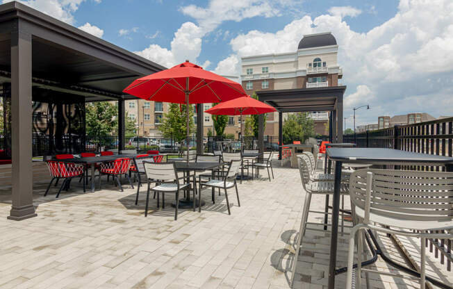 a patio with tables and chairs and umbrellas