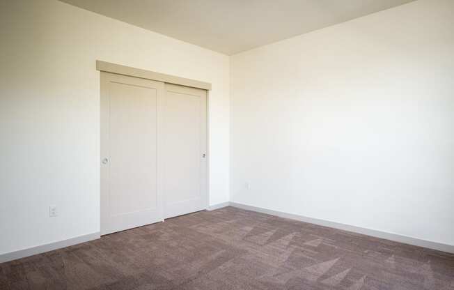 an empty room with white walls and a door