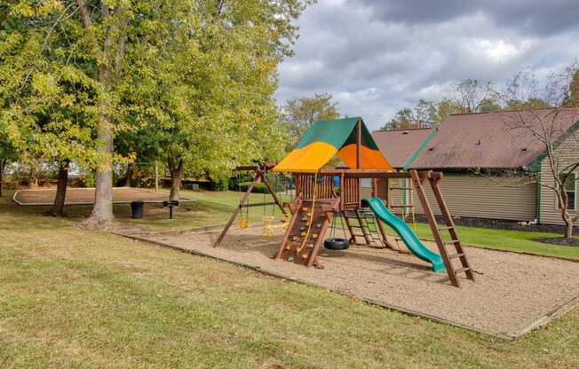 Playground in a park-like setting at Hunt Club Apartments, Integrity Realty, Copley, OH