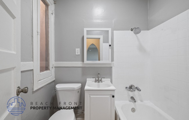 a white bathroom with a sink toilet and a tub