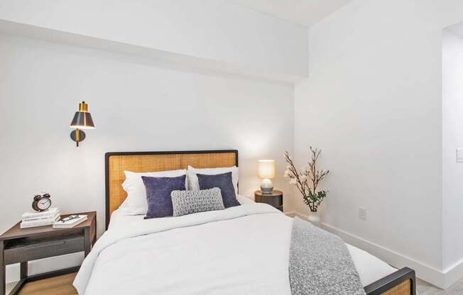 a bedroom with a bed and a nightstand with two lamps at One Plantation in Plantation, FL