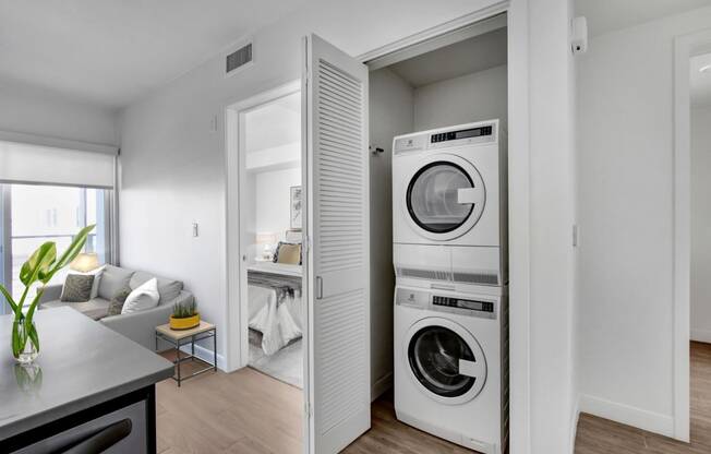 a living room with a washer and a dryer in it