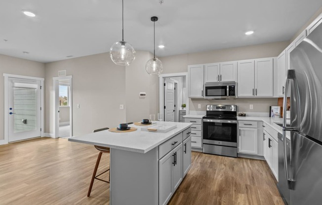 a kitchen with white cabinetry and stainless steel appliances