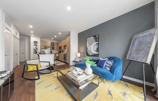 a living room with a blue couch and a table