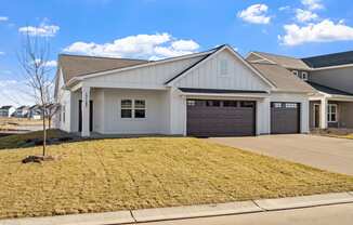 a white house with a driveway and a garage door