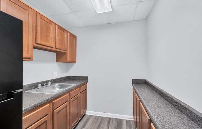 a kitchen with granite counter tops and wooden cabinets