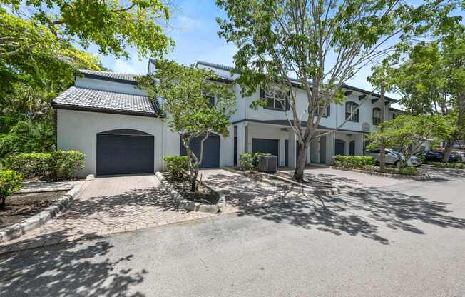a white house with a driveway and a garage door