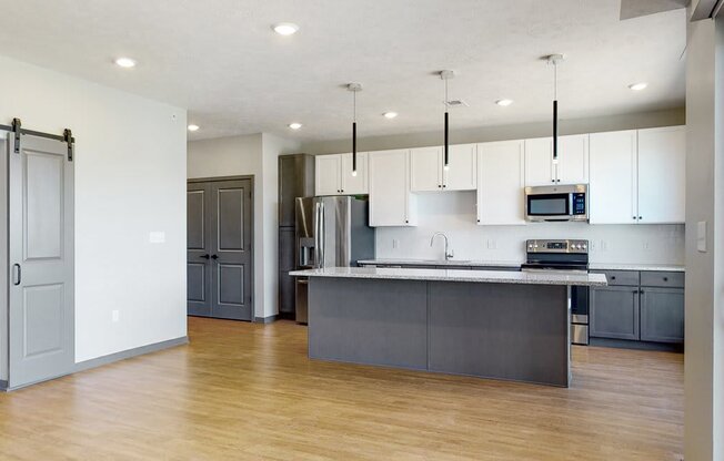 Kitchen island provides additional seating in the Melody floor plan at Haven at Uptown in Lincoln, NE