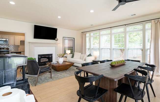 a living room with a table and chairs and a fireplace