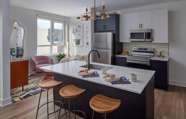a kitchen with refrigerator and white cabinets at The Weaver, Philadelphia, 19125