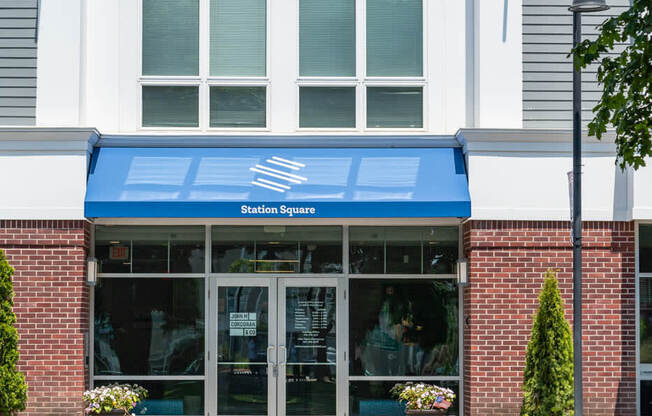 a bench in front of a building with a blue awning