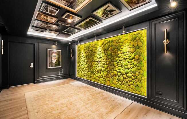 A room with a green wallpaper and a wooden floor.
