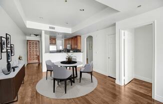 a dining room with a table and chairs and a kitchen