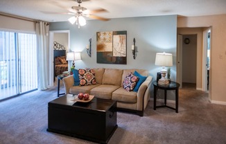 a living room with a couch and a coffee table at The Summit Apartments, Memphis, TN, 38128