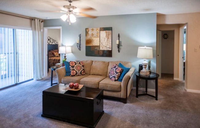 a living room with a couch and a coffee table at The Summit Apartments, Memphis, TN, 38128