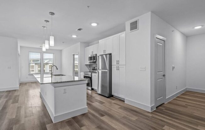 a room with a white wall and a wooden floor