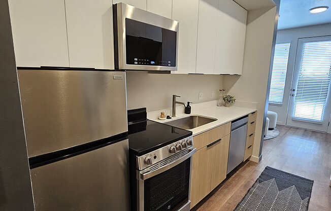 a kitchen with stainless steel at Lotus Republic Apartments for rent in Downtown Salt Lake City, Utah