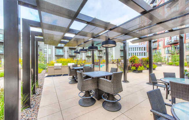 Outdoor seating under a sun terrace with heat lamps hanging above