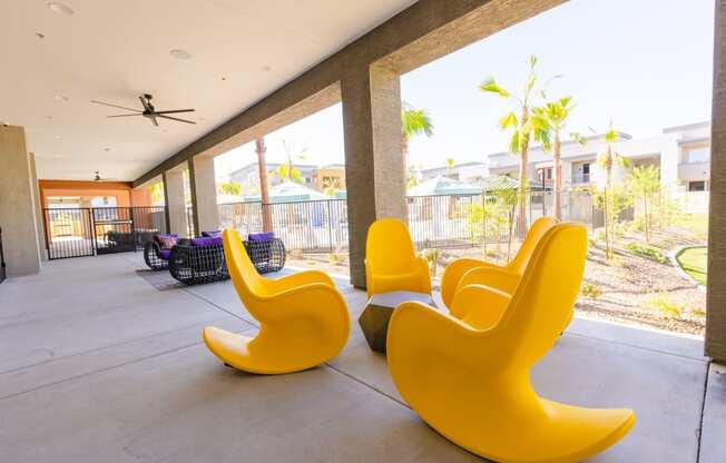 furnished lobby with yellow chairs and a view of palm trees